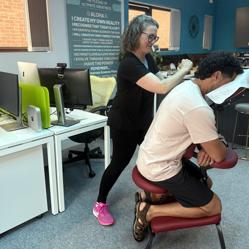 Massage therapist working on shoulder tension